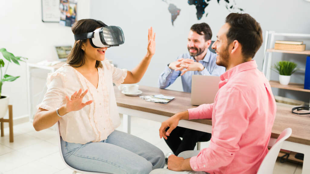 Couple seen real state with VR glasses at a real state office